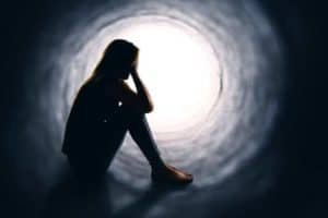 Depressed woman in a tunnel