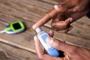 Finger getting pricked for a blood sugar test