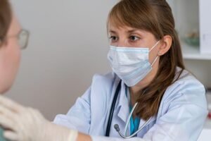 Doctor examining a patient Credit: Natalia Gdovskaia via Getty Images