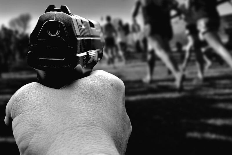 Hand pointing gun at runners