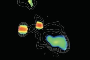 This image, taken by the Very Long Baseline Array (VLBA), shows two supermassive black holes, which appear as the blobs with red strips. The black holes are in the center of an elliptical galaxy. Colors represent different spectral slopes in radio emission, with red showing the most dense regions surrounding the black holes. The black hole on the right has likely recently devoured a massive star, which caused it to shoot out two ultrafast jets. The ends of those jets appear as green blobs above and below the black hole. This object, called J0405+3803, is referred to as a Compact Symmetric Object (CSO), because its jets are relatively close-in (or compact), compared to other black holes with much larger jets.