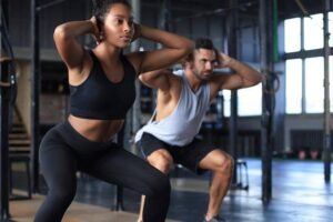 Man and woman working out next to each other